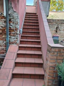 a staircase leading up to a brick building at DolceVita Apartments N 241 in Venice