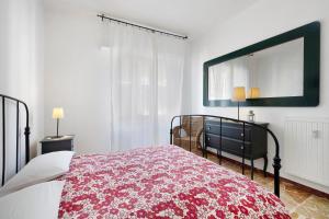 a bedroom with a bed and a large mirror at Marina in Finale Ligure