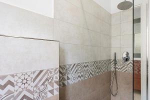 a bathroom with a shower with a glass door at Marina in Finale Ligure