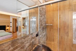 a bathroom with a glass shower with a sink at Alpi Flo Chalet in Livigno +80 photos