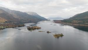 an aerial view of a river with mountains at Faodail in Onich +17 photos