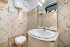 a bathroom with a sink and a toilet at Villa Martina in Costa Rei +22 photos