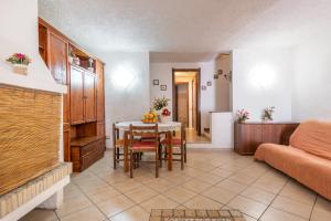 a living room with a table and a couch at Villa Martina in Costa Rei