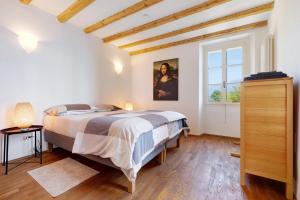 a bedroom with a large bed and a window at Haus mit tollem See -und Bergblick in Gargnano +37 photos
