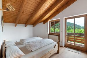a bedroom with a bed and a large window at Felsenland Idyll in Erfweiler