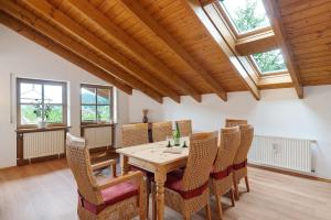 a dining room with a wooden table and chairs at Felsenland Idyll in Erfweiler