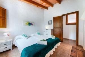 a bedroom with two beds with green sheets at Yuma in Llucmajor +20 photos