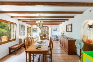 a kitchen and dining room with a table and chairs at Yuma in Llucmajor
