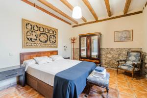 a bedroom with a large bed and a chair at Laguna Herrera in Campo de Cuéllar +30 photos