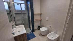 a bathroom with a sink and a toilet and a shower at Villa Taliala in Alcamo Marina +29 photos