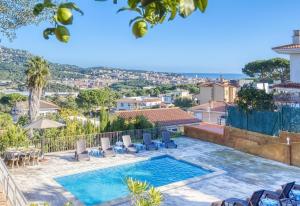 a villa with a swimming pool and a view at Costacabana - Villa Abigail in Lloret de Mar