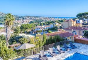 a villa with a swimming pool and lounge chairs at Costacabana - Villa Abigail in Lloret de Mar