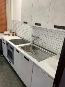 a kitchen with a sink and a counter top at Wohnung mit grandiosem Ausblick in Tremosine Sul Garda +16 photos