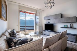 a living room with two couches and a television at Wohnung mit grandiosem Ausblick in Tremosine Sul Garda