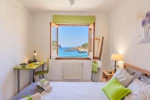 a bedroom with a view of the ocean from a window at Bellavista Port de Soller in Port de Soller