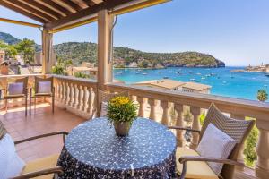 a table on a balcony with a view of the water at Bellavista Port de Soller in Port de Soller
