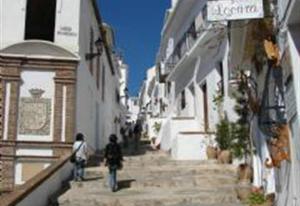 a group of people walking down a stone street at Casa Galesa in Nerja
