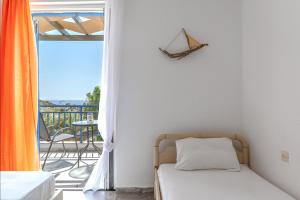 a bedroom with a bed and a balcony at Perasma Studio 1b in Kipri