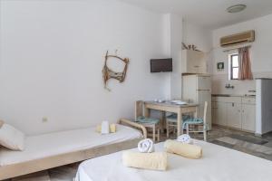 a living room with two beds and a kitchen at Perasma Studio 1b in Kipri +14 photos
