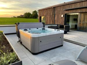 a hot tub sitting on top of a patio at Chalet Am Ried in Bad Wurzach +52 photos