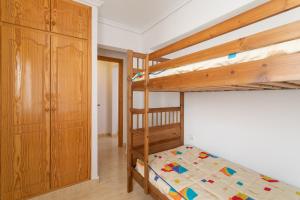 a bedroom with two bunk beds and a closet at Bungalow Desired Track in Santa Pola +18 photos