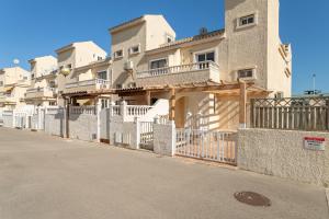 a building with a fence in front of it at Bungalow Desired Track in Santa Pola