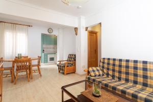 a living room with a couch and a table at Bungalow Desired Track in Santa Pola