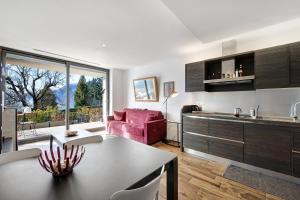 a kitchen and living room with a red couch at La Grande Bellezza in Perledo