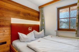 a bedroom with two beds and a window at Gästehaus Panorama - Appartement 2 in Reit im Winkl