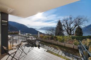 a house with a balcony with a view of mountains at La Grande Bellezza in Perledo