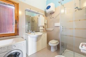 a bathroom with a sink and a washing machine at Casa Erbì in Torre Dei Corsari +22 photos