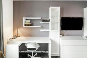 a white desk with a computer and a monitor at Ferienwohnung am West-östlichen Tor in Ecklingerode
