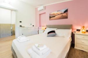 a bedroom with a bed with towels on it at Su Carinniu in Villacidro