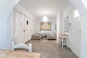 a living room with a bed and a table at Livadia Seaside Studios 1 in Parikia