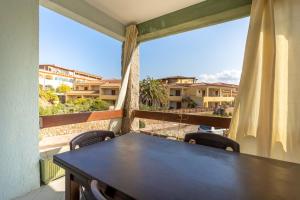 a table and chairs on a balcony with a view at Casamorle in Isola Rossa