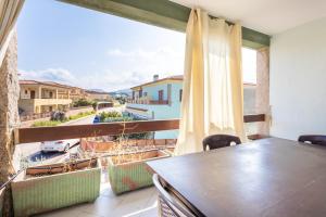 a balcony with a table and a view of a city at Casamorle in Isola Rossa