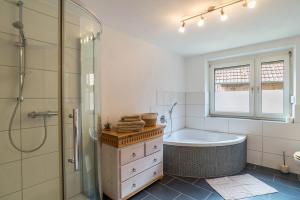 a bathroom with a tub and a shower and a sink at Pfälzerwald Idyll in Schwanheim +31 photos