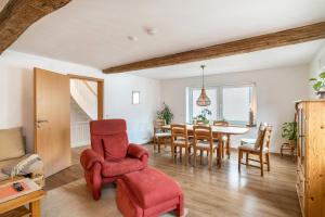 a living room with a dining room table and chairs at Pfälzerwald Idyll in Schwanheim