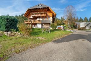 a wooden house with a sign in front of it at Krährbauernhof mit Hofladen in Hornberg