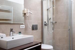 a bathroom with a sink and a shower at Kriendl Nr 3 in Valdaora +16 photos