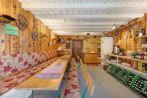 a room with wooden walls with benches and a refrigerator at Krährbauernhof mit Hofladen in Hornberg