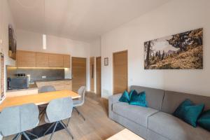 a living room with a couch and a table at Kriendl Nr 3 in Valdaora