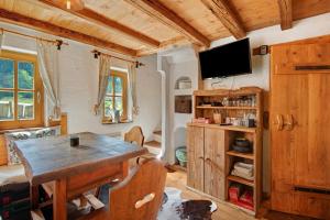 un soggiorno con un tavolo e una TV a parete di Tiny Hideaway Bayerischer Wald a Sankt Englmar