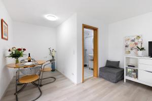 a room with a table and a chair and a desk at Albgängerle in Mössingen +11 photos