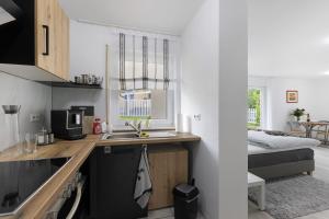a small kitchen with a sink and a bed at Albgängerle in Mössingen