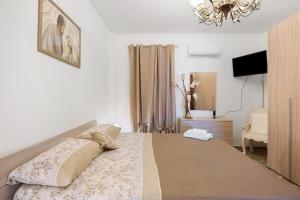 a bedroom with a bed and a chandelier at Holidayshouse in Ercolano