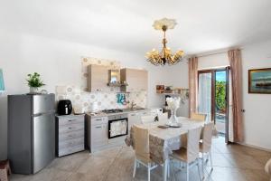 a kitchen with a table and a refrigerator at Holidayshouse in Ercolano