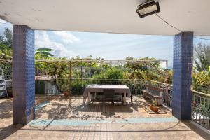 a patio with a table and chairs on a balcony at Holidayshouse in Ercolano