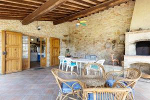 a patio with a table and chairs and a fireplace at La Ripa - Appartamento Padronale in San Gimignano