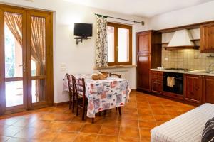 a kitchen with a table with a table cloth on it at Fresia Quadrilocale in Marina di Grosseto